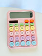 Miso station pastel pink desktop calculator with large, multi-colored circular buttons and a clear LCD display.