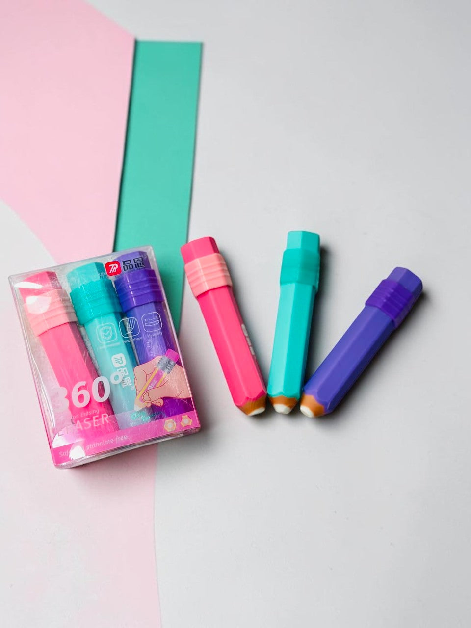 Miso station pencil shaped erasers in pink, teal, and purple, featuring a clear storage case on a white textured background.
