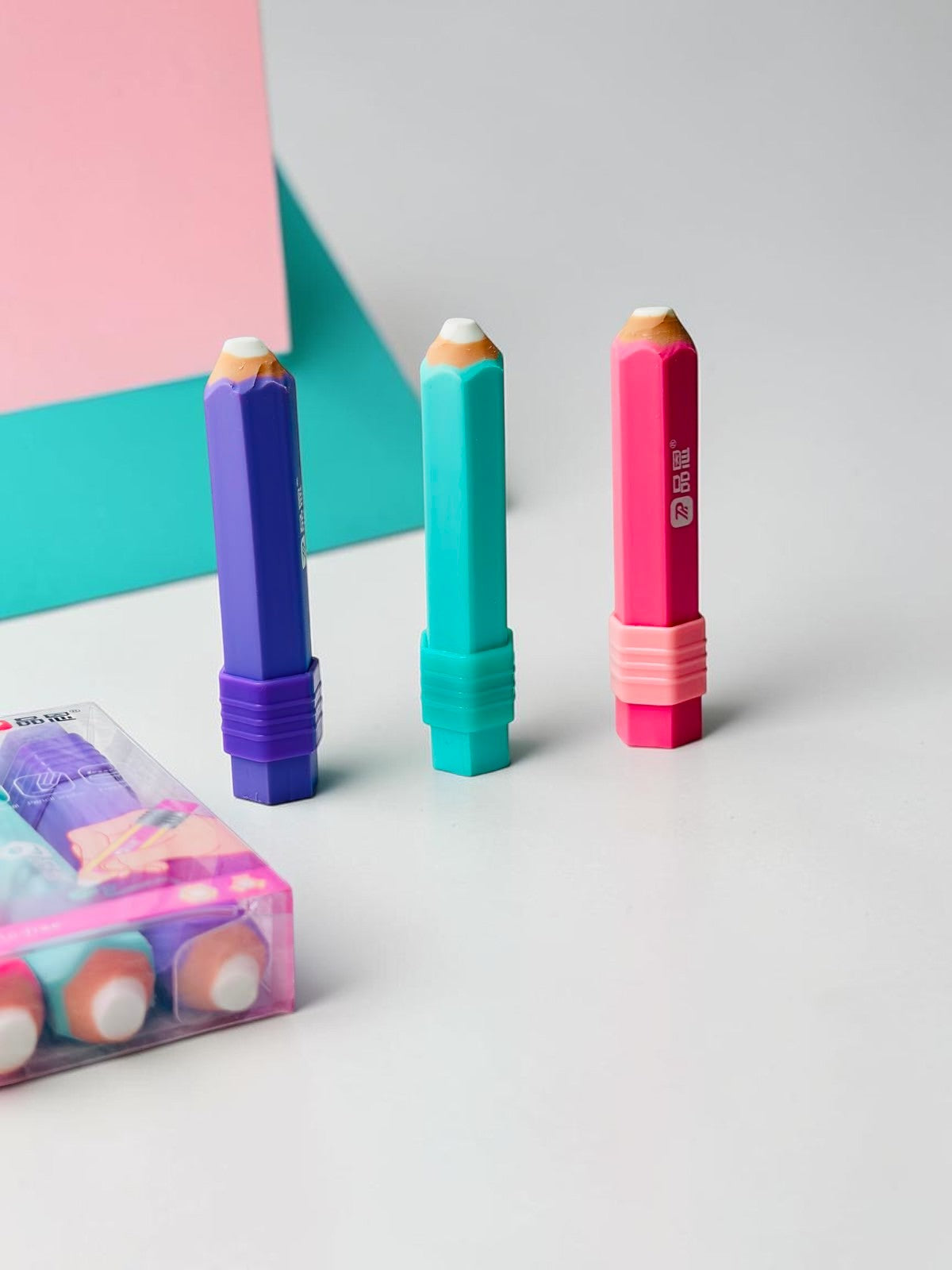 Miso station set of three pencil-shaped erasers in vibrant purple, teal, and pink for precision erasing.