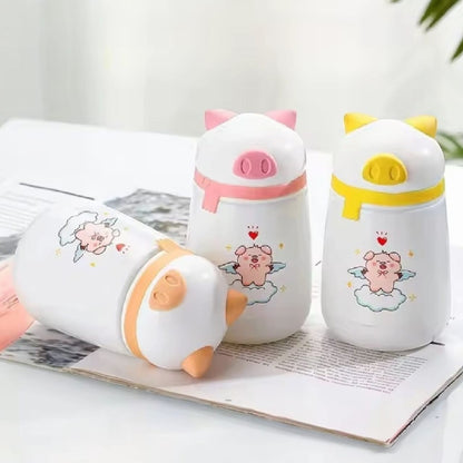 Miso station white stainless steel insulated water bottles featuring cute pig characters with angel wings and scarves.