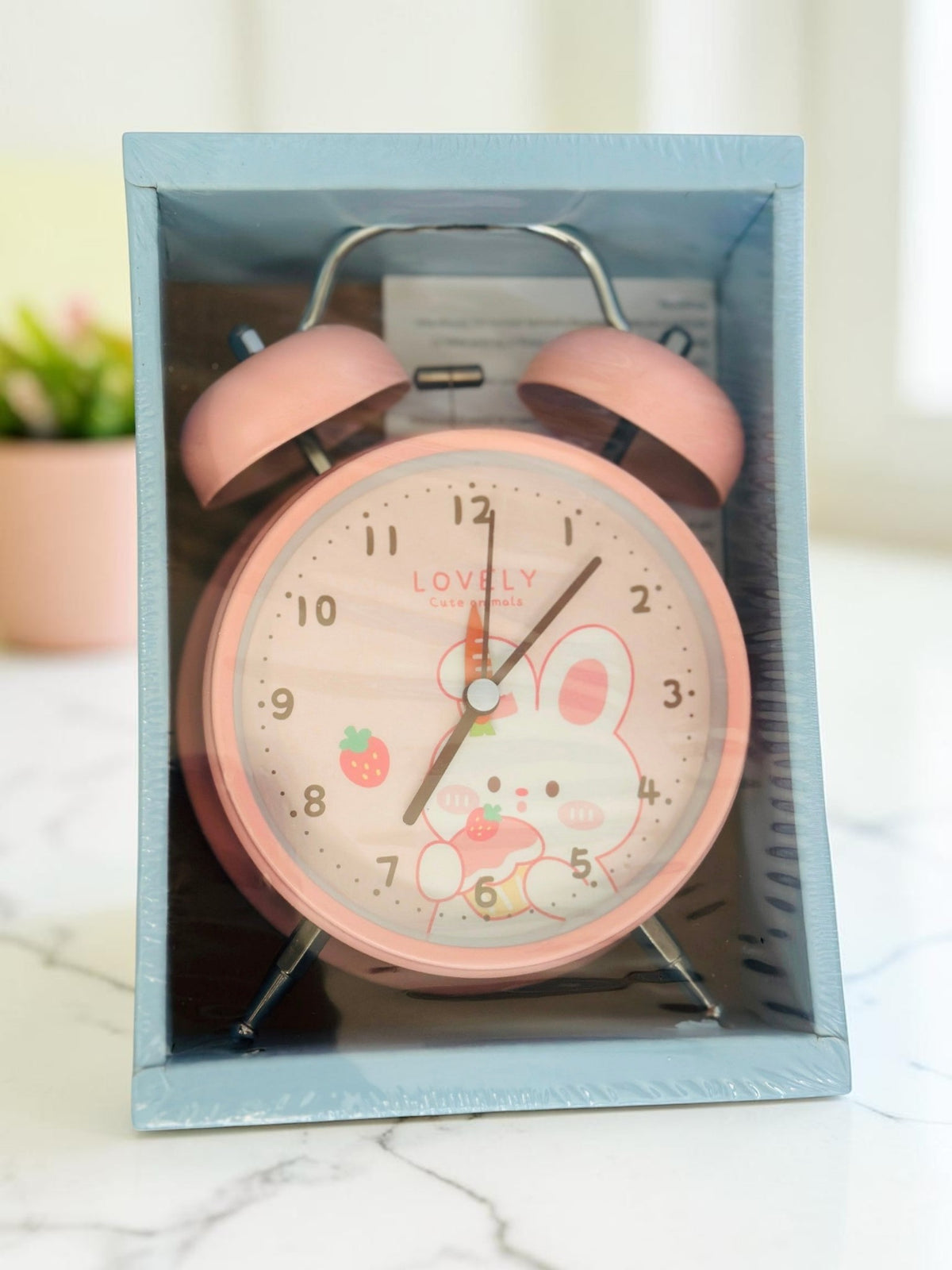 Miso station pink twin-bell analog alarm clock featuring a cute bunny illustration on the dial in its box