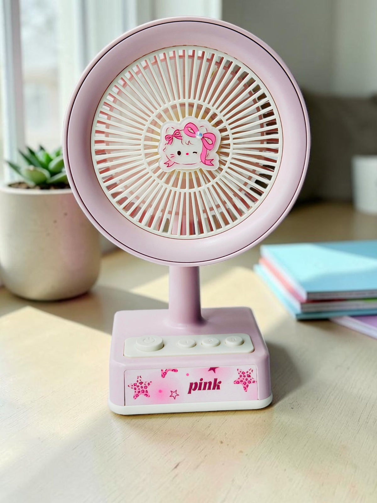 Miso station pink portable desk fan with a cute cartoon cat character centerpiece and simple control buttons.