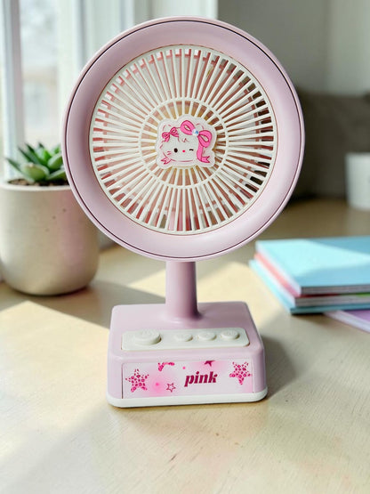 Miso station pink portable desk fan with a cute cartoon cat character centerpiece and simple control buttons.