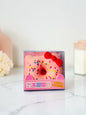 Miso station pink cat ear donut stress relief toy with colorful sprinkles and a red bow in clear display packaging.