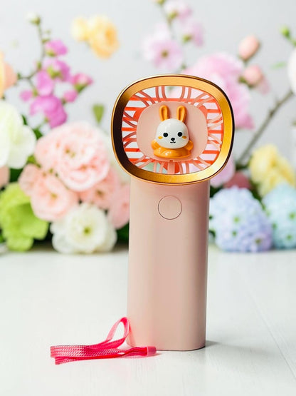 Miso station portable handheld fan in pastel pink with a cute rabbit character and gold-tone rim and wrist strap.