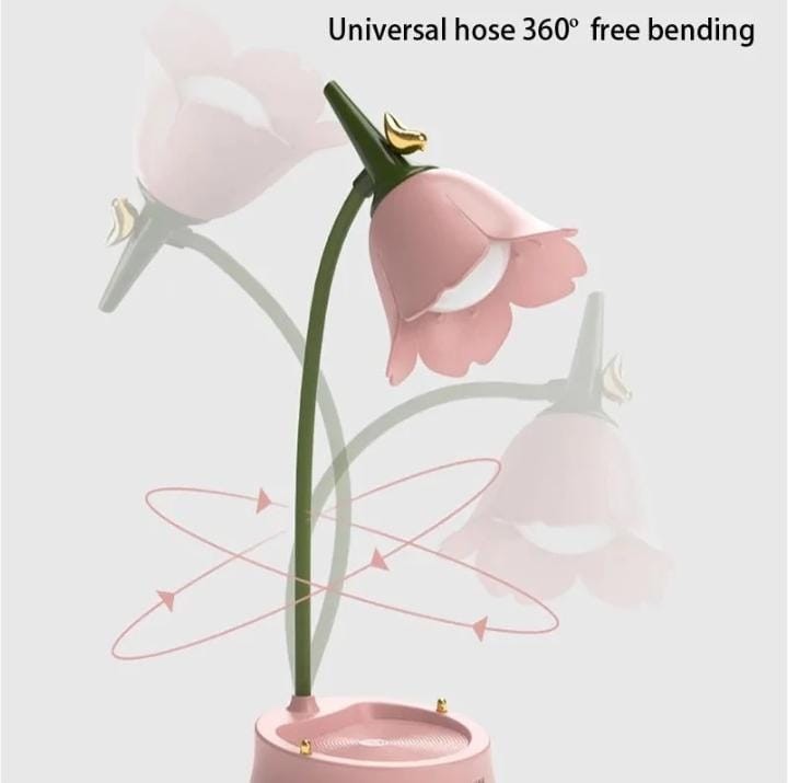 Miso station pink tulip-shaped desk lamp with a flexible green hose neck and integrated stationery storage base.