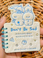Miso station plush spiral memo notepad with a cute cartoon character cover and Don't Be Sad text in cream color