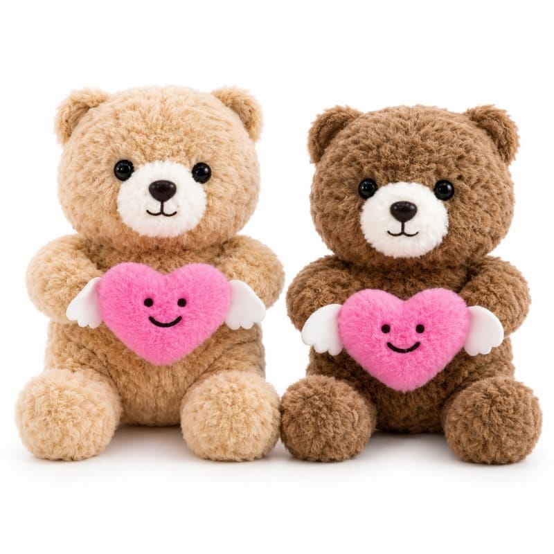 Miso station plush teddy bears in tan and brown holding pink hearts with white wings on a white background