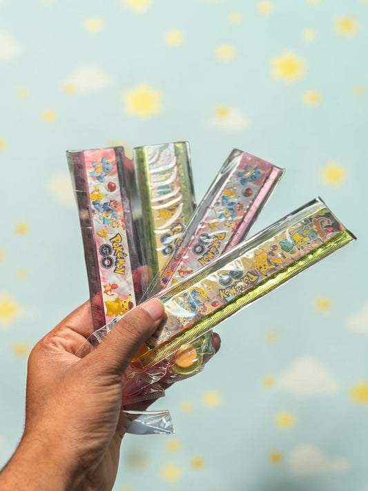 Miso station Pokemon themed folding rulers in clear plastic packaging held in a hand against a blurred outdoor background