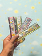 Miso station Pokemon themed folding rulers in clear plastic packaging held in a hand against a blurred outdoor background