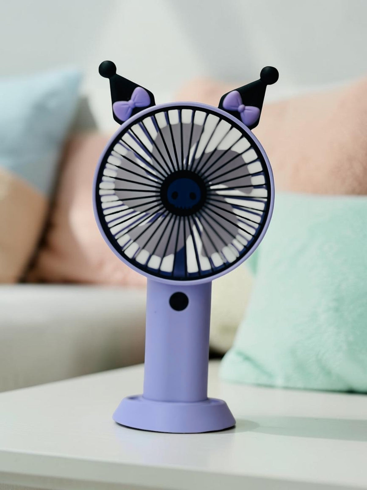 Miso station portable handheld desk fan in purple and black with cute character ears and bows on a white table