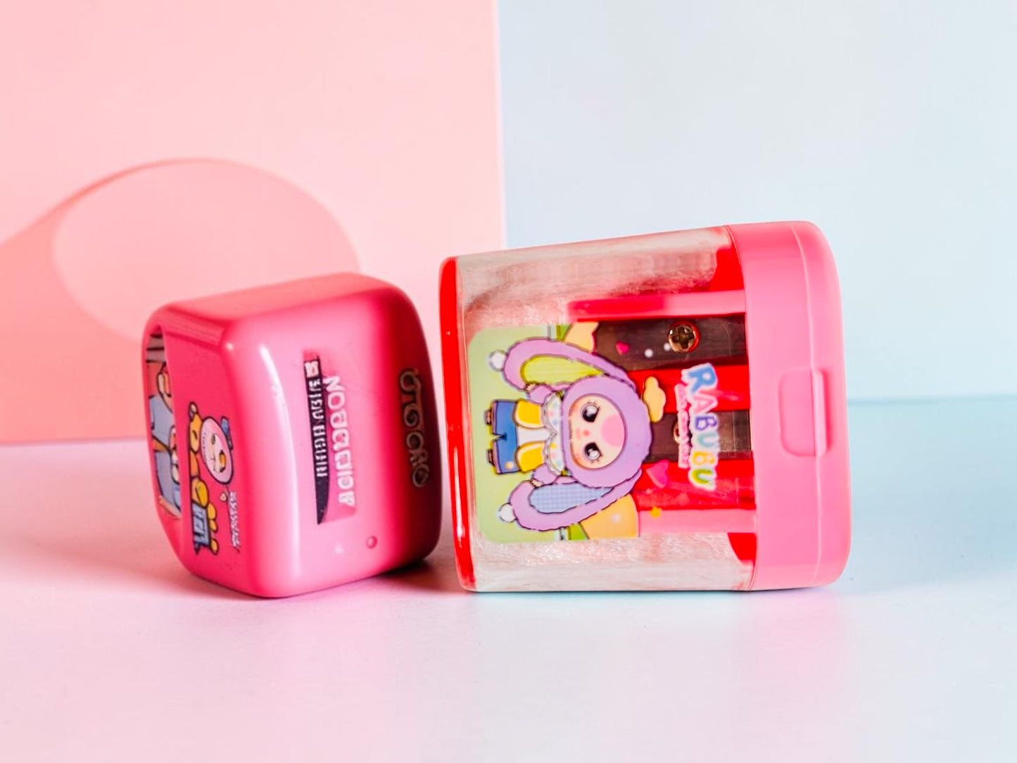 Miso station RABUBU character two-hole pencil sharpener with a pink lid and transparent shavings container.