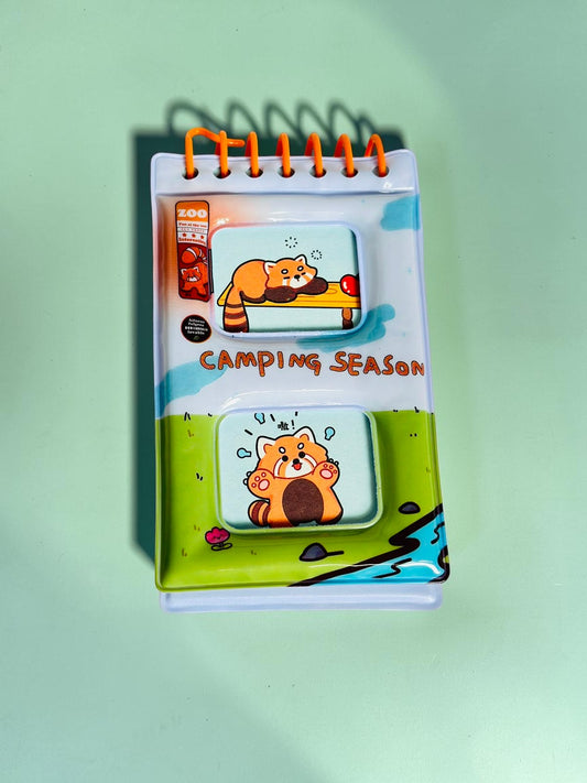 Miso station Camping Season pocket notebook featuring a cute red panda illustration with orange spiral binding