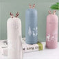 Miso station insulated stainless steel water bottles in white, blue, and pink with rose gold reindeer antler lids.