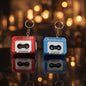 Miso station red and blue retro cassette tape keychains with detailed reels and vintage typography on a dark surface.