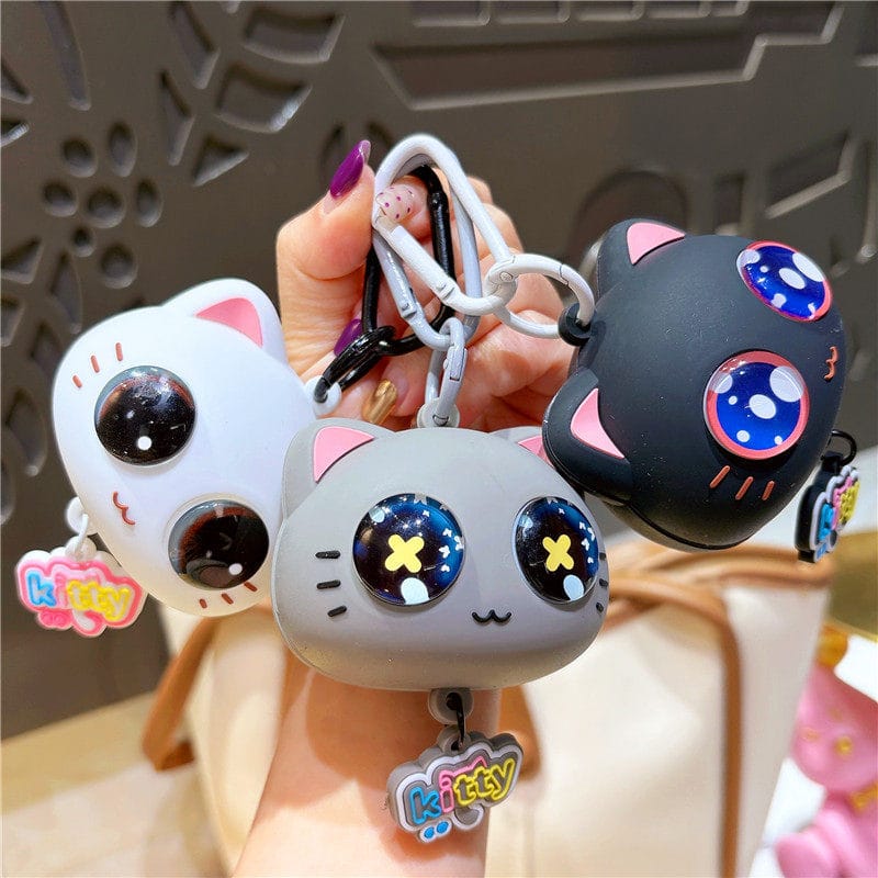 Miso station silicone cartoon cat keychains in white, grey, and black with large expressive eyes and kitty charms