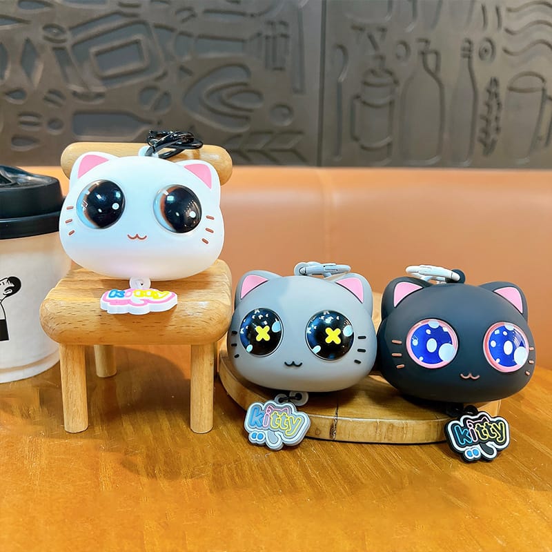 Miso station silicone cartoon cat keychains in white, grey, and black with large expressive eyes and kitty tags