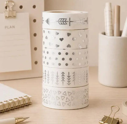 Miso station decorative washi tape set featuring silver foil patterns like hearts and geometric shapes on a desk.