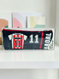 Miso station soccer jersey themed pencil case in black and red with number 11 graphic and zipper closure