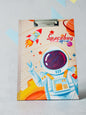 Miso station space-themed clipboard featuring an astronaut, rocket, and integrated ruler on a white textured background