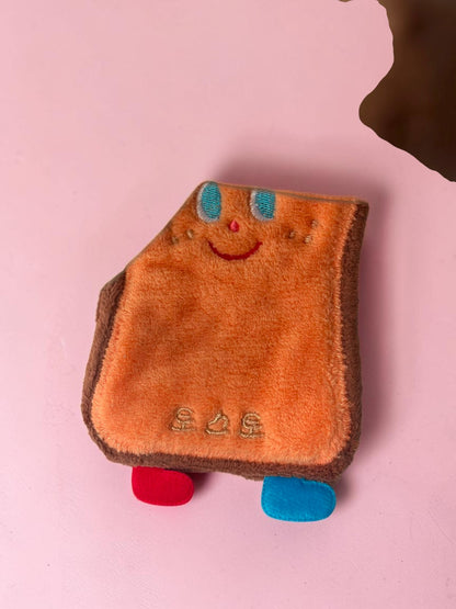 Miso station toast-shaped cleaning sponge with a cute embroidered face, orange plush texture, and small colorful feet.