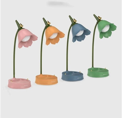 Miso station tulip-shaped desk lamps in pink, orange, blue, and green with flexible necks and storage tray bases.