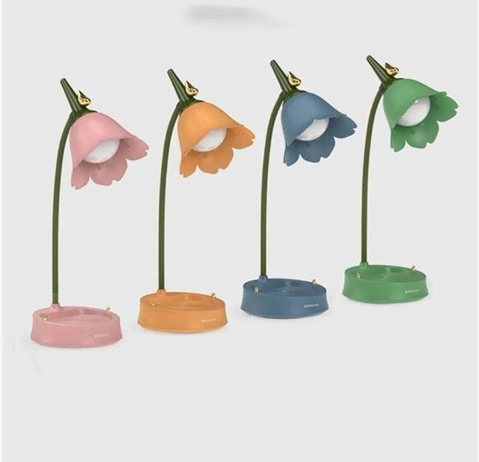 Miso station tulip-shaped desk lamps in pink, orange, blue, and green with flexible necks and storage tray bases.