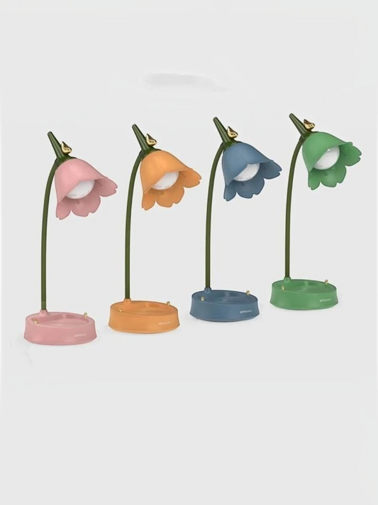 Miso station tulip-shaped desk lamps in pink, orange, blue, and green with flexible necks and storage tray bases.