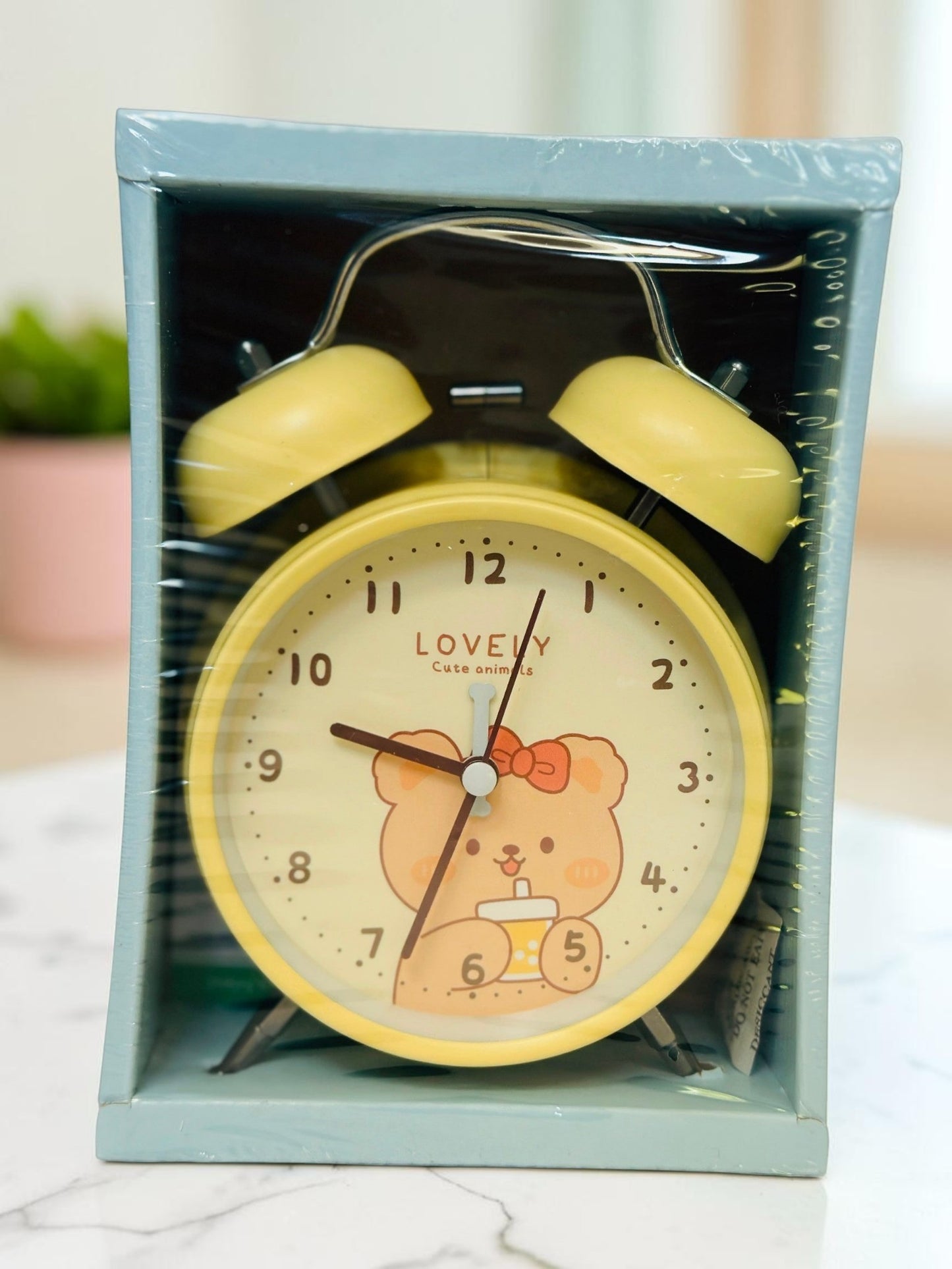 Miso station yellow twin-bell analog alarm clock with a cute bear illustration on the dial in its original packaging.