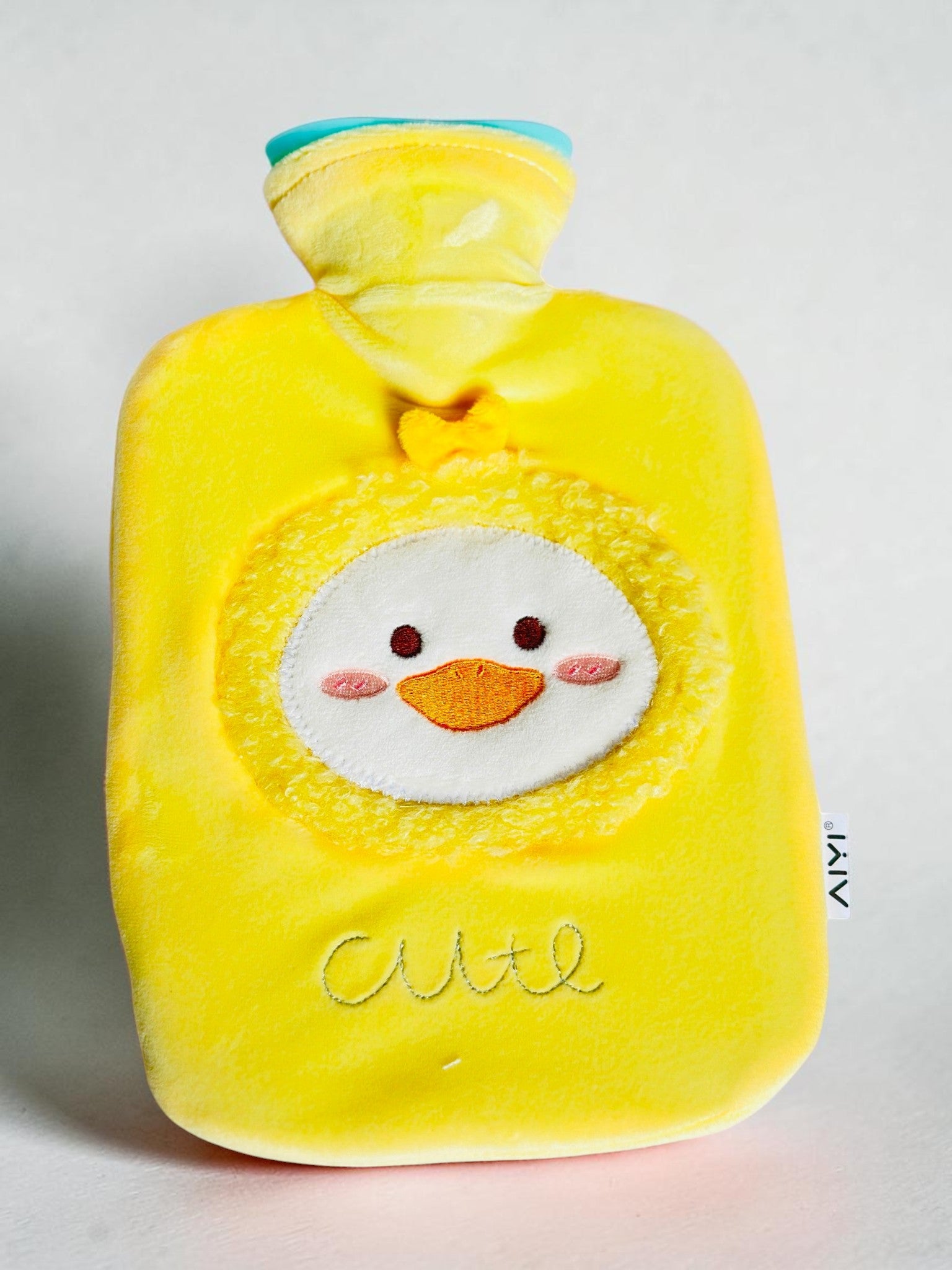 Miso station yellow plush hot water bottle with a cute embroidered duck character applique and soft velvet cover.