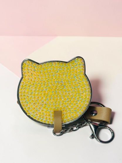 Miso station cat-shaped compact mirror with a yellow glitter finish, metallic edge, and a convenient keychain attachment.