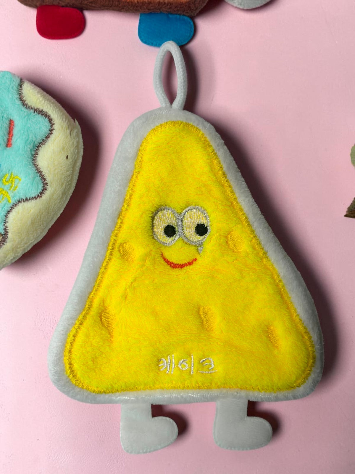 Miso station yellow triangular snack-shaped kitchen sponge with a cute embroidered face and hanging loop